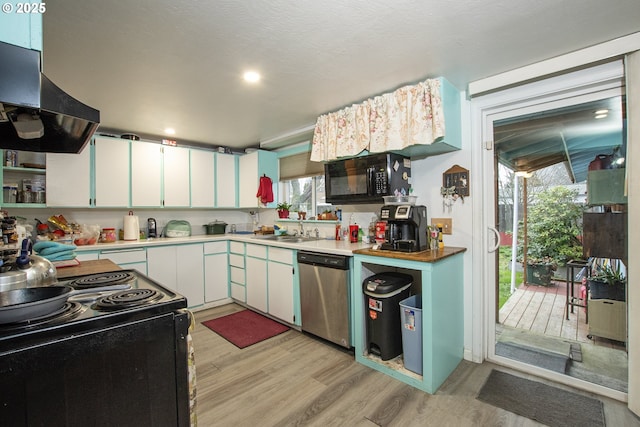 kitchen with sink, white cabinets, light hardwood / wood-style flooring, exhaust hood, and black appliances