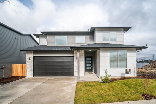 view of front of house featuring a front yard and a garage