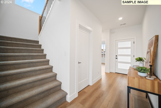 foyer entrance with light wood-type flooring