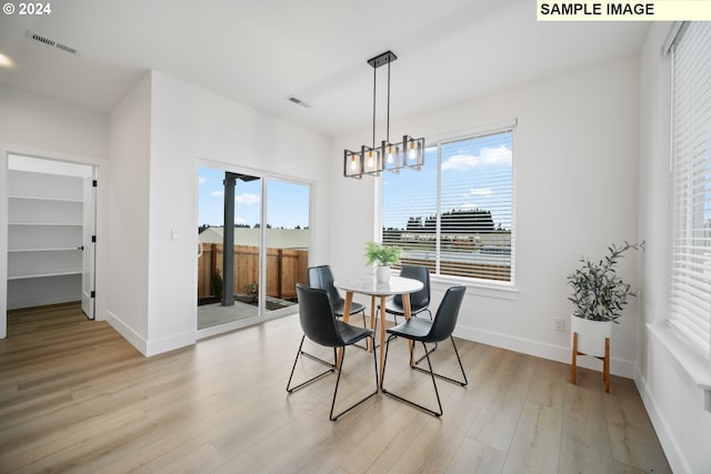 dining room featuring light hardwood / wood-style flooring and a chandelier