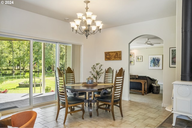 dining room featuring ceiling fan with notable chandelier