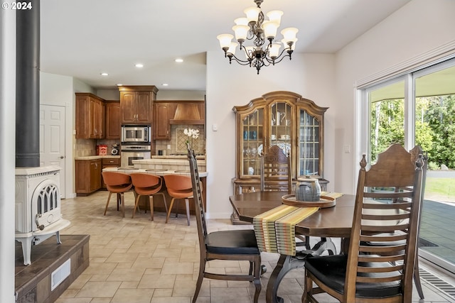 dining space featuring a chandelier and sink