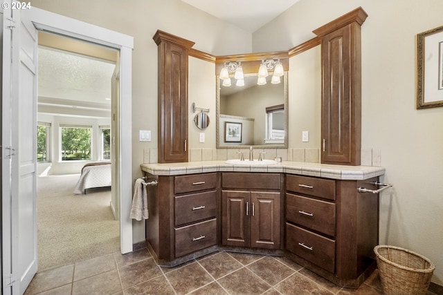 bathroom with tile patterned flooring, a textured ceiling, and vanity