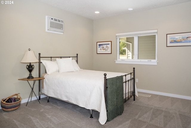 bedroom featuring carpet and a wall unit AC