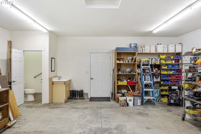 garage with a garage door opener, electric panel, and a workshop area