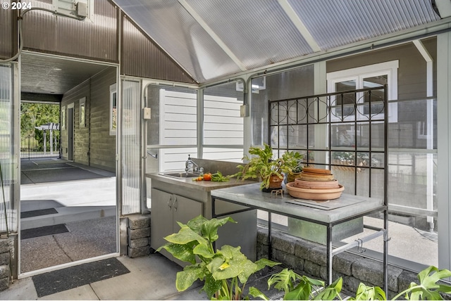 sunroom / solarium with lofted ceiling and sink