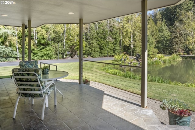 unfurnished sunroom featuring a water view