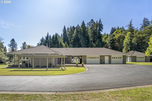 ranch-style house featuring a garage and a front yard