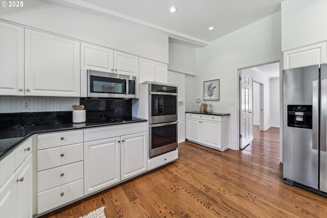 2585 Dellwood Dr, Lake Oswego, OR 97034 - kitchen with white cabinets, recessed lighting, appliances with stainless steel finishes, and wood finished floors