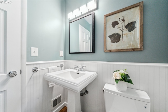 2585 Dellwood Dr, Lake Oswego, OR 97034 - half bathroom with visible vents, wainscoting, and toilet