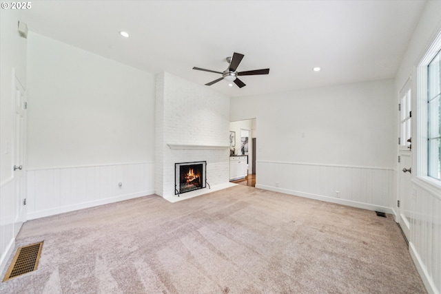 2585 Dellwood Dr, Lake Oswego, OR 97034 - unfurnished living room featuring plenty of natural light, carpet, a wainscoted wall, a ceiling fan, and visible vents