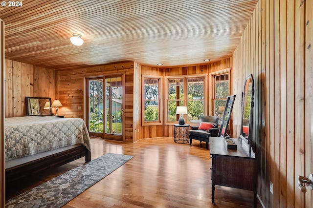 bedroom featuring access to exterior, wood ceiling, and wood-type flooring