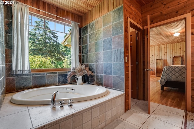 bathroom featuring tile patterned floors, tiled tub, and wooden ceiling