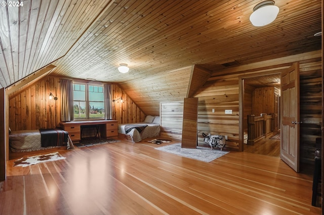 additional living space featuring wood walls, lofted ceiling, and wood ceiling