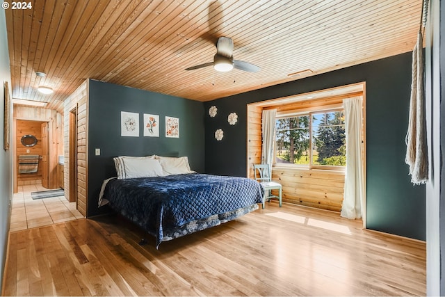 bedroom with ceiling fan, wood-type flooring, and wood ceiling