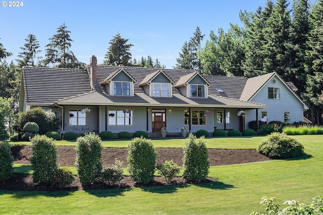 cape cod home with a front lawn