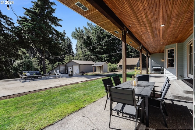 view of patio featuring outdoor lounge area and a storage shed