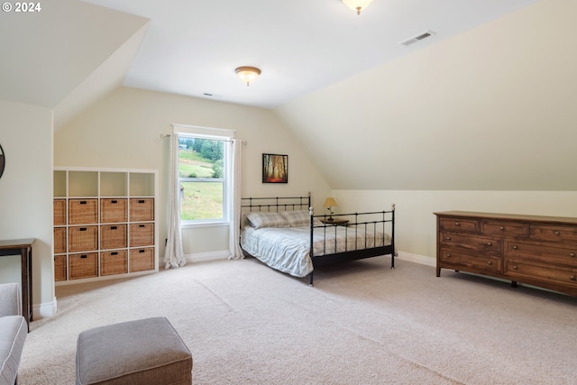 carpeted bedroom with vaulted ceiling