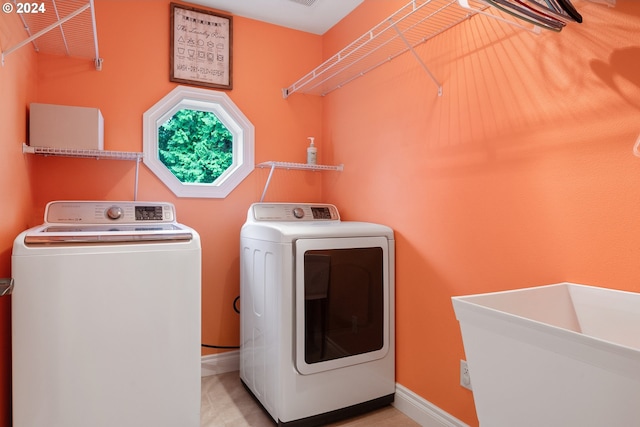 washroom with sink and washer and dryer