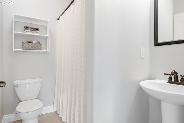 bathroom featuring tile patterned flooring, sink, and toilet