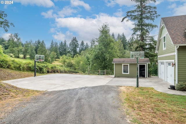 view of basketball court featuring a yard