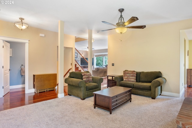 carpeted living room with ceiling fan