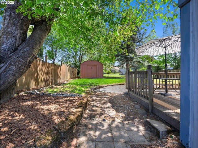 430 SE Elliott Ave, Gresham, OR 97080 - view of yard featuring fence, a wooden deck, an outdoor structure, and a storage unit