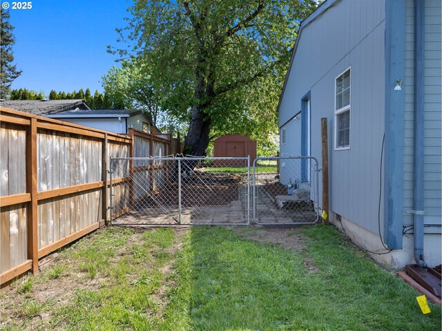 430 SE Elliott Ave, Gresham, OR 97080 - view of yard with an outbuilding, a gate, a fenced backyard, and a shed