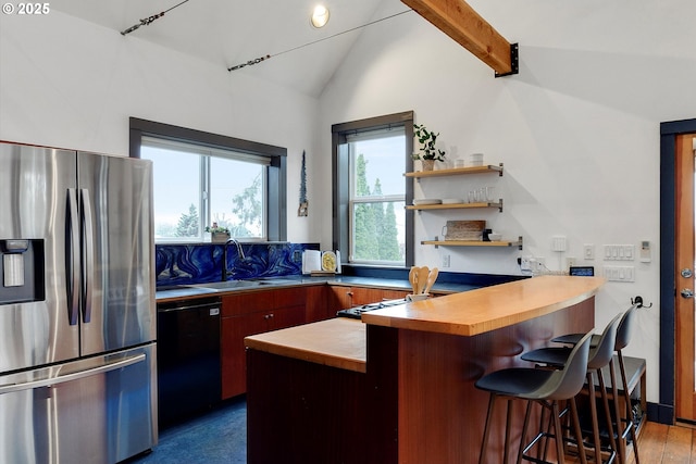 kitchen with stainless steel fridge, lofted ceiling with beams, dishwashing machine, a peninsula, and a sink