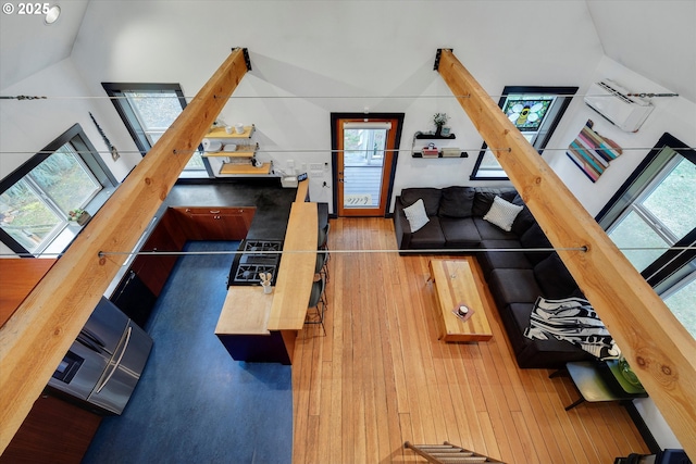 living room featuring lofted ceiling, stairway, and wood finished floors