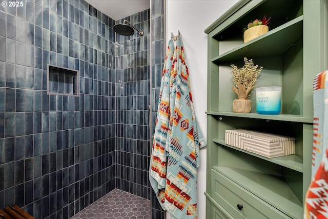 bathroom with a tile shower