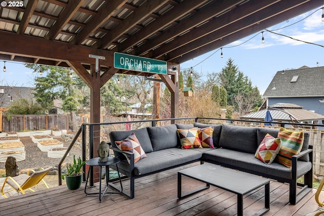 wooden deck featuring an outdoor hangout area and fence