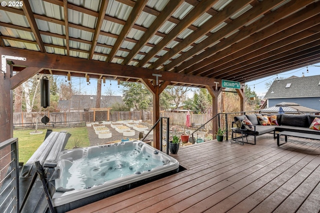 wooden deck with a yard, a fenced backyard, and hot tub deck surround