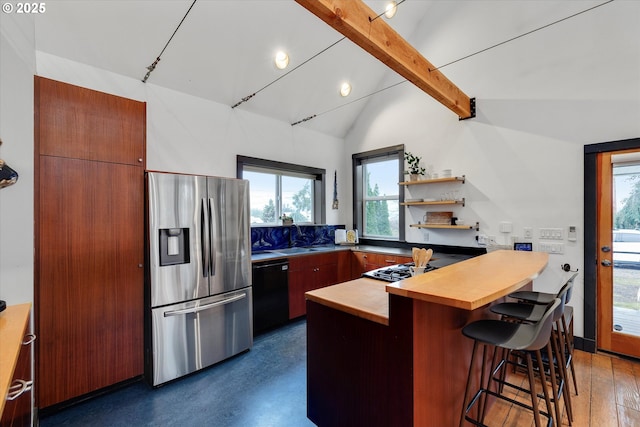 kitchen with stainless steel fridge, dishwasher, lofted ceiling with beams, butcher block countertops, and a kitchen bar