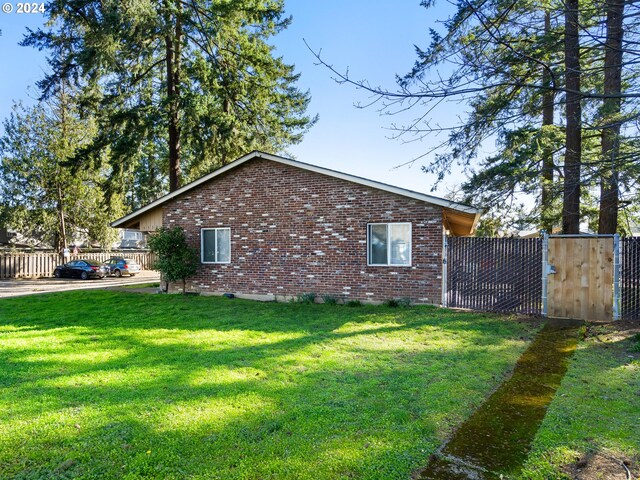 view of property exterior with a yard