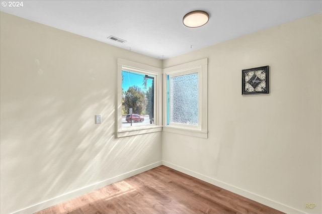 unfurnished room featuring hardwood / wood-style flooring