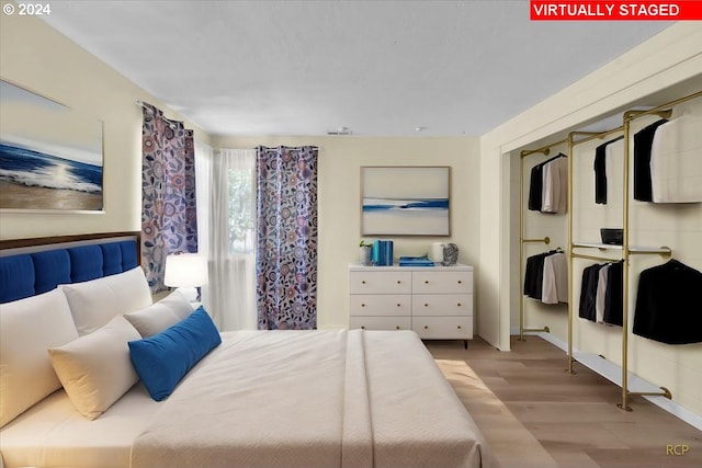 bedroom with light hardwood / wood-style floors