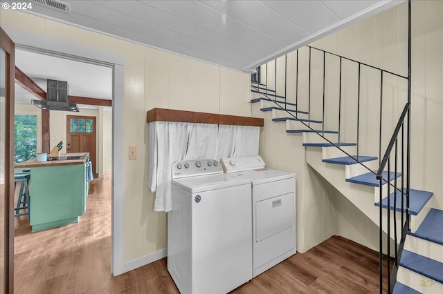 washroom featuring separate washer and dryer and light hardwood / wood-style flooring