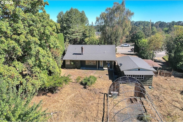 rear view of house featuring an outbuilding