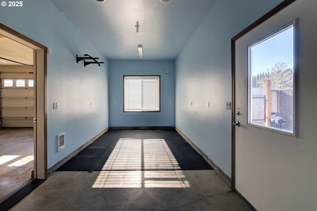 unfurnished dining area featuring concrete flooring, visible vents, and baseboards