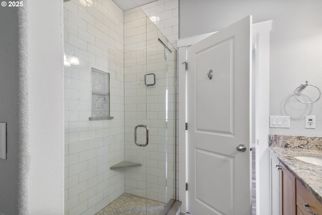 full bath featuring a shower stall and vanity