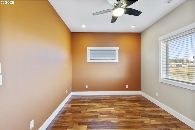 unfurnished room with recessed lighting, wood finished floors, and baseboards