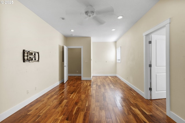 unfurnished room featuring ceiling fan, baseboards, dark wood-type flooring, and recessed lighting