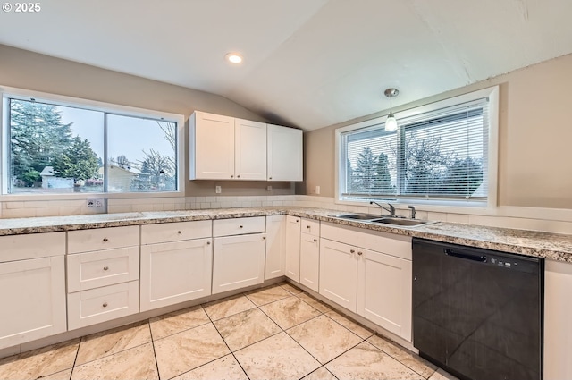 kitchen featuring lofted ceiling, sink, dishwasher, pendant lighting, and white cabinets