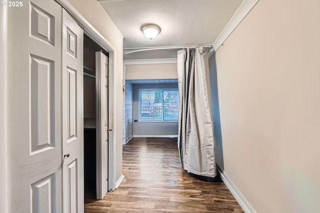 corridor with hardwood / wood-style flooring and crown molding