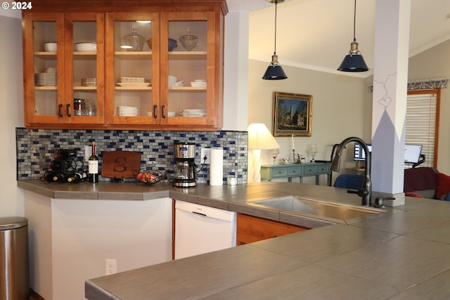 bar featuring decorative light fixtures, stainless steel counters, sink, decorative backsplash, and white dishwasher