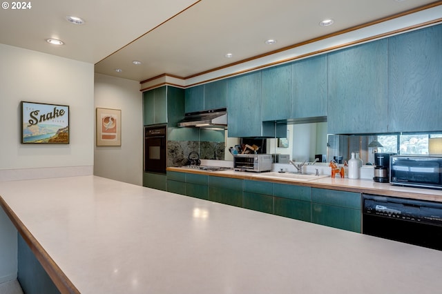 kitchen with green cabinets, kitchen peninsula, sink, and black appliances