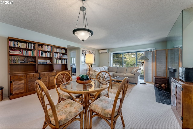 dining space featuring a wall mounted air conditioner, light carpet, and a textured ceiling