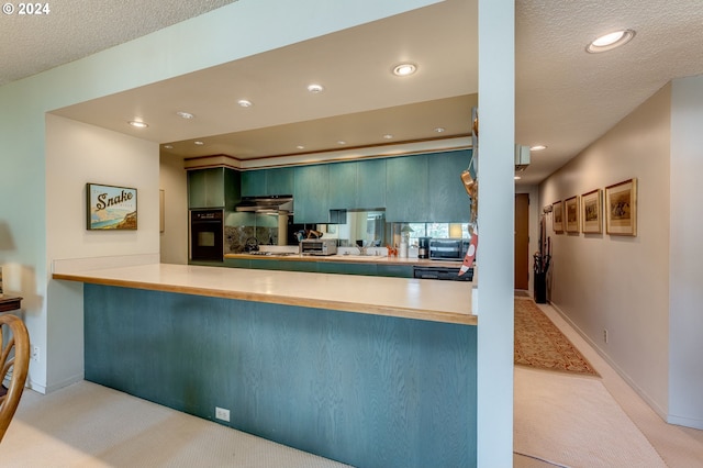 kitchen with light colored carpet, black appliances, kitchen peninsula, and a textured ceiling