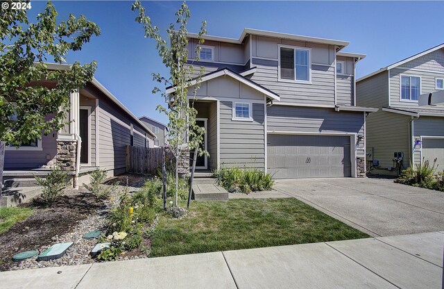 view of front of property with a garage and a front lawn